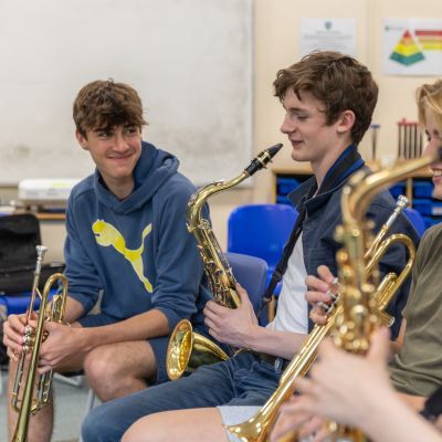 Three boys playing the saxophone